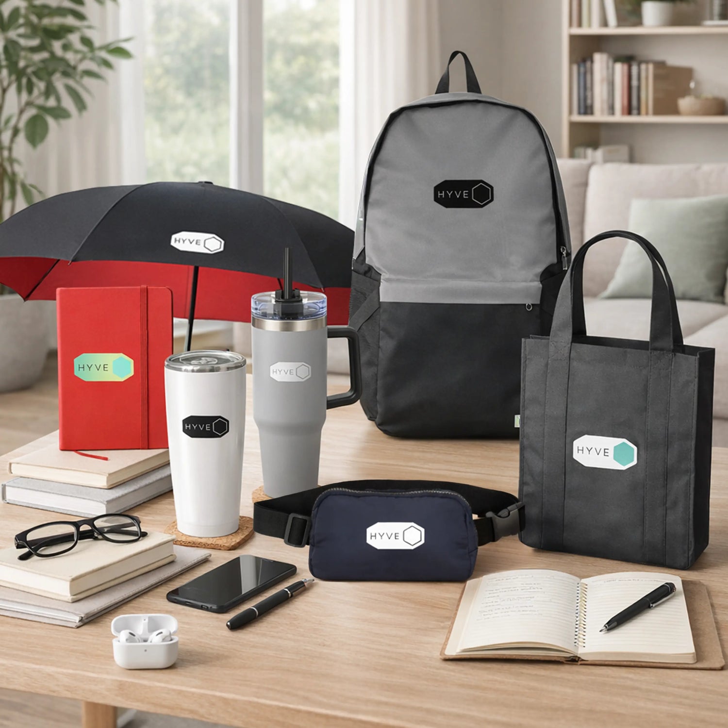 HYVE branded corporate gifts collection including tumbler, backpack, tote bag, umbrella, belt bag, notebook and earbuds