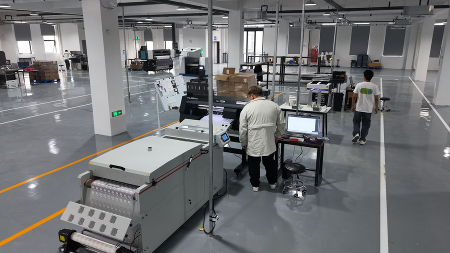Factory floor with workers operating machinery and computers