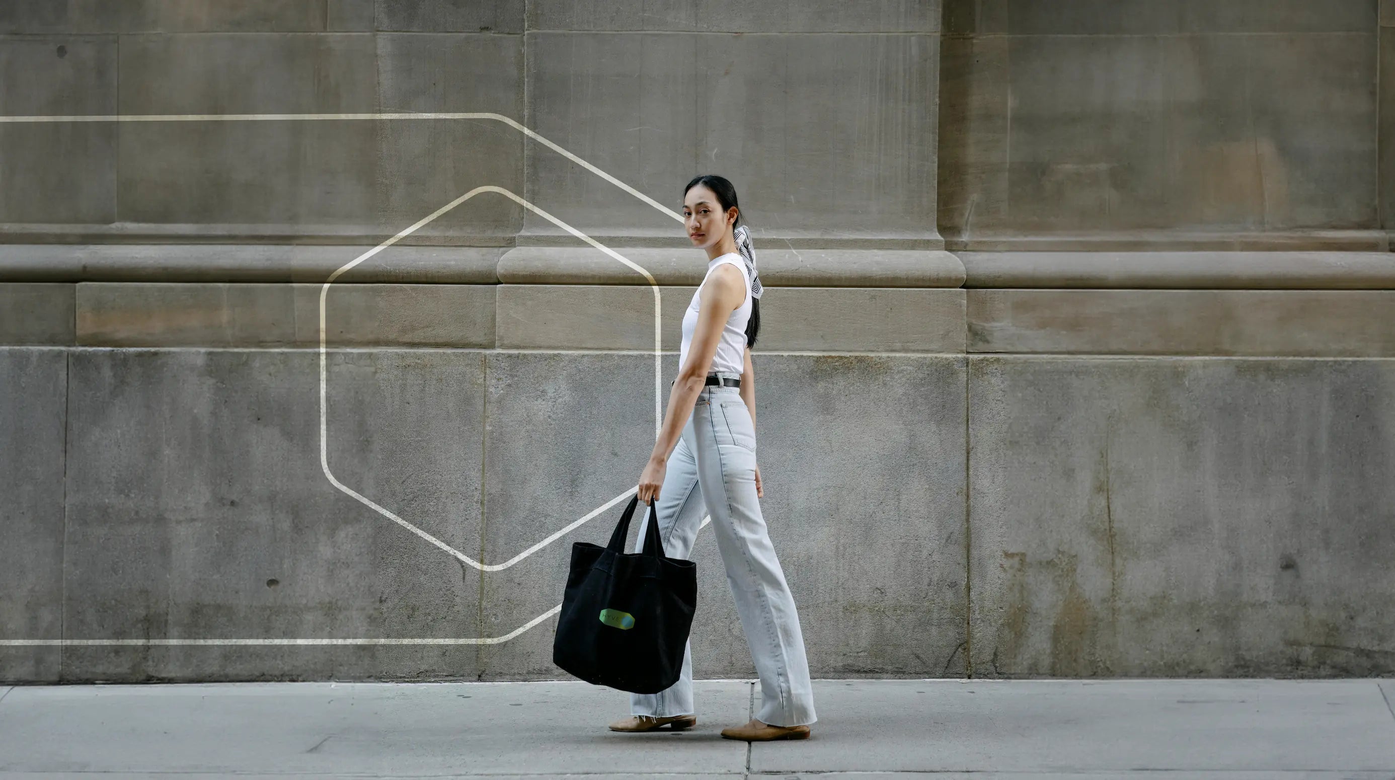 Woman with Hyve branded merchandise — lifestyle